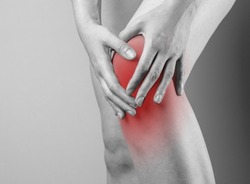 Knee cap, meniscus pain, trauma close up. Hand touching injured red kneecap. High quality photo