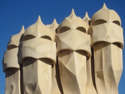 Scenic chymneys on the rooftop of La Pedrera in Barcelona, Spain. The famous luxury house designed by the architect Gaudì. This is a detail of the building also named Casa Milà