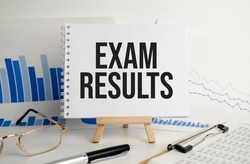 exam results words on notebook and pen on white background