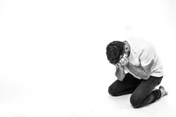 Young man isolated over background. Picture of man in depression and desperate state. Heartbroken breakdown person alone in room or studio. Failrue, sadness or shame stress.