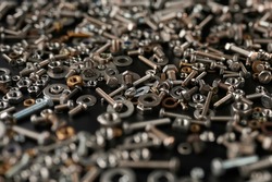 tilt shift photography.background with nuts, bolts, screws, which are focused in the center with blurred background.