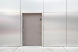 close grey door with aluminium or steel wall