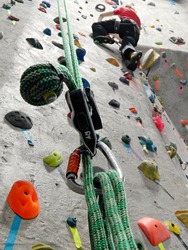 A man rockclimbs on a wall