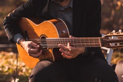 A male musician plays an acoustic guitar at a wedding for live music 