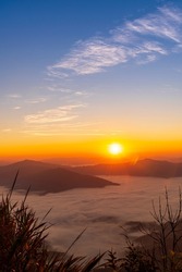 Sunrise or Sunset Landscape of the mountain and sea of mist in winter sunrise view from top of Doi Pha Tang mountain , Chiang Rai, Thailand