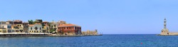 Panoramic view of the entrance to Hania harbour, Crete, Greece, with the traditional architecture of the old town. Names have been removed