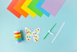 A paper butterfly made of colored paper. LGBT Characters Step-by-step instructions. Step 2. Glue and twist.