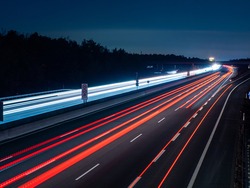 long exposure from a german autobahn at nighttime with lightrays of the carlights 