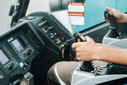 Close up of a hand holding the control stick and ready to work in the truck crane the largest truck crane for challenging tasks.