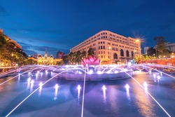 A lotus-shaped fountain with nice lights on Nguyen Hue street walking in front of Ho Chi Minh statue and Ho Chi Minh People's Committee, Saigon, Ho Chi Minh City, Vietnam. 