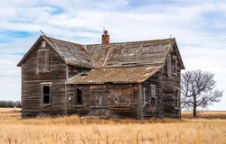 Neglected abandon barn. Dilapidated farm house