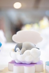 Penguin toy. A baby penguin plastic toy is having a sweet dream sleeping on the cotton cloud. Good night concept. Soft focus on the penguin's face