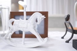 A mini rocking horse toy for decoration or display, a childhood memory, a white horse carousel, nostalgic concept