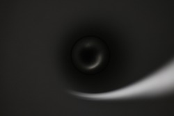 Abstract blury dark background with a circle shaped dim light on a sphere and an elegant, gradient light wave spiraling out from it.