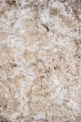 Close up view of a lightbrown stone texture with rugged surface. Space for copy.
