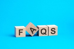 faqs - word is written on wooden cubes close-up. bright blue background, financial business concept. faqs - short for Frequency Asked Questions