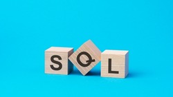sql text on wooden blocks, financial business concept, blue background. sql - short for Structured Query Language