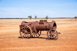 An old rusted farm steam engine, now abandoned and on display in outback country, Australia.