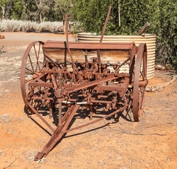 An old fashioned seeder, now abandoned farm machinery on a farm in outback country, Australia.