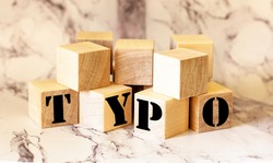 Word typo of wooden blocks on a marble table