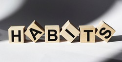 The word Habits written on wooden cubes and white background
