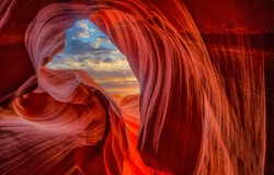 Cave light in abstract naturally red sandstone rock mountains