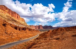 The road through the canyon on a clear day. Canyon road in desert. Beautiful canyon road landscape. Road in red rock canyon landscape