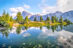 Clouds are reflected in a mountain lake. Mountain lake view. Lake in mountains. Mountain lake landscape