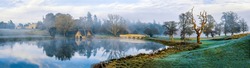 Panoramic landscape of pond in morning fog