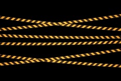 Yellow and black lines of barrier cross tape prohibit passage, tape on black isolate background. Barrier that prohibits traffic. Danger unsafe area warning tape do not enter. Concept no entry
