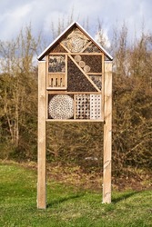 Insect house on a meadow. Protection for animals and the environment. A way to bring nature into the city. Also suitable for rural regions. Also called bug house.
