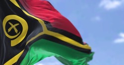 Detail of the national flag of Vanuatu waving in the wind on a clear day. Vanuatu is an island country located in the South Pacific Ocean. Selective focus.