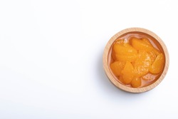 Pickled peeled oranges in syrup in a cup.on a white background.