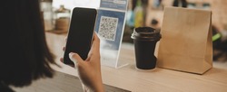 Panoramic banner. customer using digital mobile phone scan QR code pay for buying coffee in cafe coffee shop, restaurant, digital payment, online shopping, takeaway food, internet technology concept