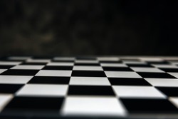 abstract blurred black and white chess board game competition on dark background, chess battle, business management, leadership success, team leader, teamwork, business strategy planning concept