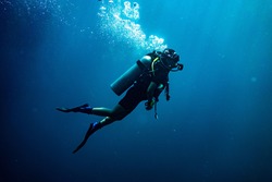 Scuba diving safety stop performed in the deep blue sea