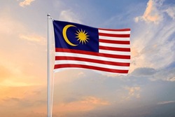 Malaysia flag waving on sundown sky