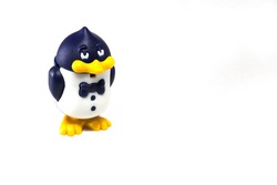 Cute plastic toy penguin isolated on white.
