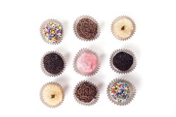 Top view of traditional brazilian sweets - brigadeiros - isolated over white background.