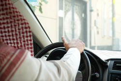 Saudi men waiting in his car.