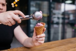 Ice cream cone. Ice cream with waffle cones. Waffle cone being held by a girl. Colorful cereal toppings for vibrance. perfect for hot summer days or winter.
