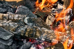 Burning coals covered by fire in the menhal, preparation of coals for grilling, hovering hearth