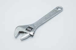 Drop forged adjustable wrench with chrome finish for maximum resistance against corrosion on white background. Precision-machined slide jaw and worm gear allows for exact fastener fit and adjustment