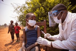 Open air vaccination session in an african village during corona virus pandemic.
