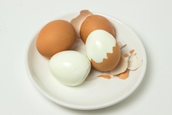 Boiled eggs on a white background. Shelled egg. Cooking chicken eggs