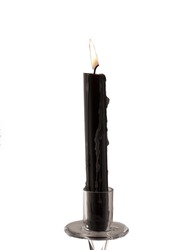 Old black candle isolated over white background