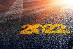 motivational writing happy new 2022 year tyre track mark on asphalt as a metaphor for moving forward calender in happy new year background for greeting card design top slide cover calendar