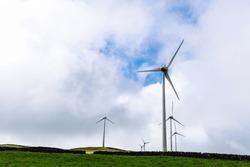 Panoramic view of wind farm or wind park, with high wind turbines for generation electricity with copy space. Green energy concept. Terceira Island, Azores, Portugal