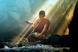 novice monk washes alms bowl in creek with stunning rays of sunlight