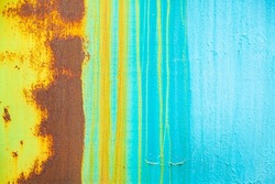 colored background - a rusty sheet of painted iron - old blue paint and rust formed a beautiful pattern, turquoise and orange vertical stripes